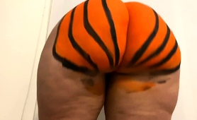 Playful Ebony Babe Shows Off Big Pumpkin Painted Booty